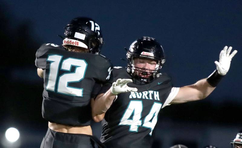 Woodstock North’s Brady Rogers, right, celebrates with Braelan Creighton after a Rogers touchdown in varsity football at Rod Poppe Field on the campus of Marengo High School in Marengo on Friday, Sept. 12, 2025.