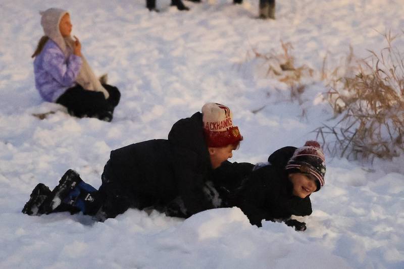 Kids play in the snow at Plainfield’s holiday kickoff Grinchmas on the Green on Saturday, Dec. 5, 2025 in Plainfield.