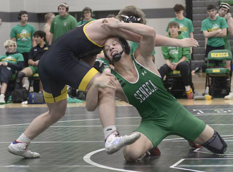 Seneca’s Gunner Varland tries to bring down Reed Custer’s Reed Newbrough in the 165# match Wednesday at Seneca.