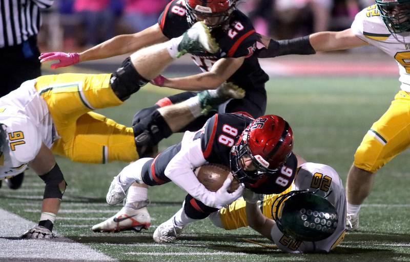 Huntley’s Connor Ardell lunges for all the yardage he can get against Crystal Lake South in varsity football action at Huntley Friday evening.