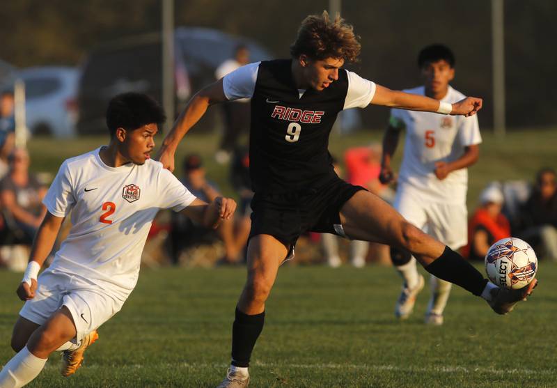 Prairie Ridge's Henry Knoll controls the ball in front of Crystal Lake Central's Joshua Hernandez during a Fox Valley Conference soccer match on Thursday, Oct. 10, 2024, at Prairie Ridge High School.
