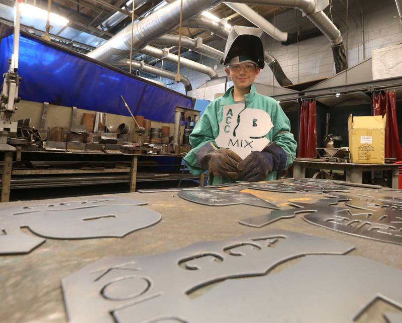 Westin Mix poses for a photo with his plate that he made  during a welding class at the Area Career Center Hands-On Showcase on Thursday, June 8, 2023 at La Salle-Peru Township High School.