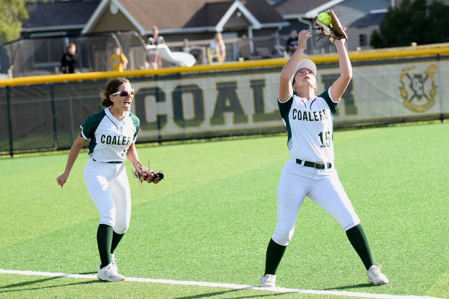 Coal City's Juliana Covington, left, begins to celebrate as Kaycee Graf catches the final out of the Coalers' 7-5 comeback win over Bishop McNamara in the IHSA Class 2A Coal City Regional championship Friday, May 23, 2025.
