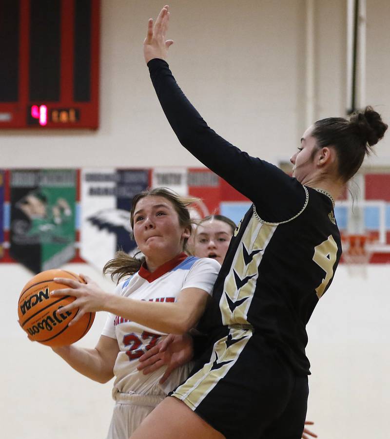 Marian Central's Jenna Remke drives to the basket against Rockford Christian's Teagan Lawver during a nononference basketball game on Monday, Feb. 10, 2025, at Marian Central High School  in Woodstock.