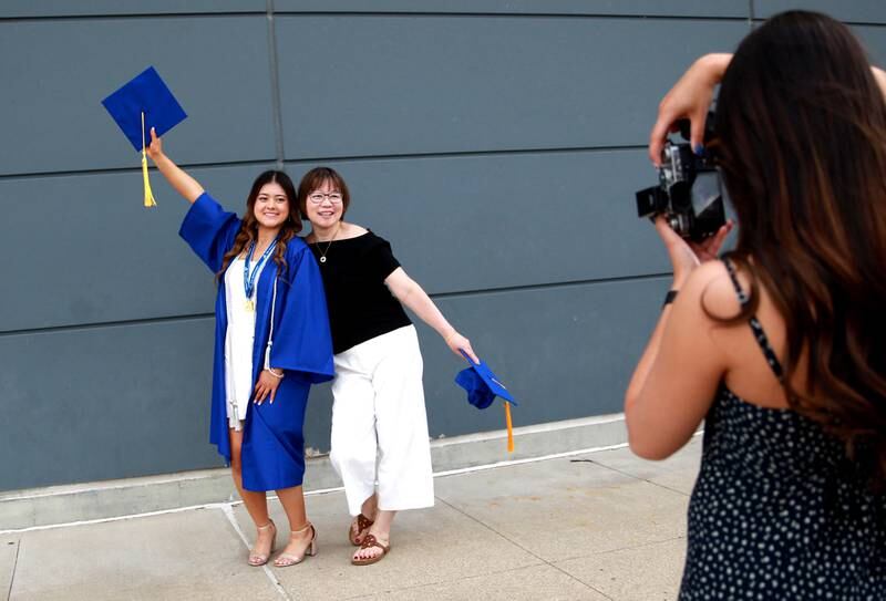 St. Charles graduate Ella Lewandowski (left) poses with her mom, Rachel, before the school’s commencement ceremony at Northern Illinois University in DeKalb on Monday, May 20, 2024.