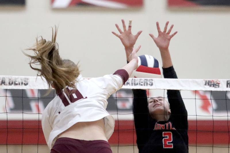 Prairie Ridge’s Addy Grider, left, hits the ball as Huntley’s Rachael Hein defends in varsity girls volleyball at Huntley High School in Huntley on Thursday, Sept. 11, 2025.