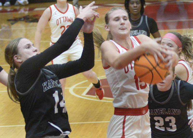 Ottawa’s Hailey Larsen pulls down a rebound before Kaneland’s Grace Brunscheen and Kendra Brown in the 4th period Friday at Ottawa.