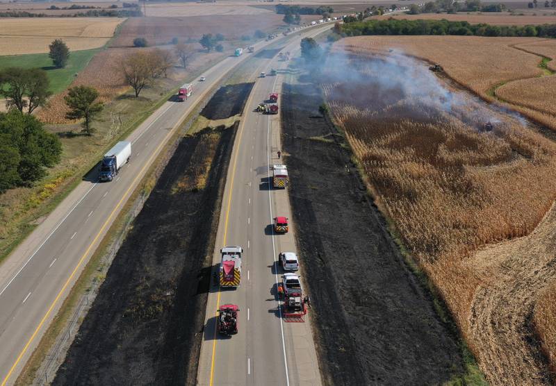 Firefighters extinguish a brushfire on Interstate 80 Eastbound near mile post 65 in Bureau County. A MABAS box alarm was sent out around 11:45 a.m. and upgraded to a fourth-alarm. Interstate 80 was shut down in the Eastbound lane while firefighters doused the flames. Fire companies from Utica, Oglesby, Ladd, Bureau, Hennepin, Peru, La Salle, Spring Valley and others responded to the scene.