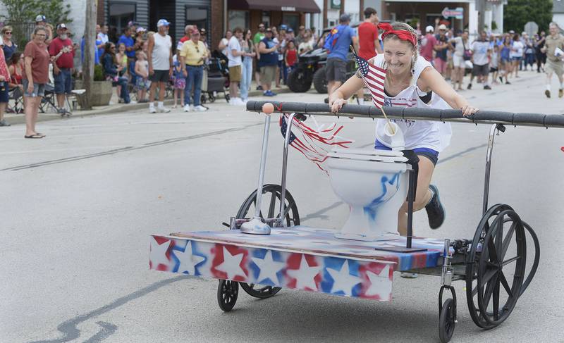Team Clyde’s Creation builds up speed on Si Johnson Ave during the annual Toilet Bowl Races as part of the towns 4th of July celebration.