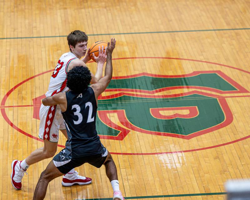 Gavin Stokes (33) of LaSalle-Peru maneuvers ball as Kaneland's Tyler Adams (32) defends on Friday, Feb. 20, 2026 in Sellett Gymnasium at L-P High School.
