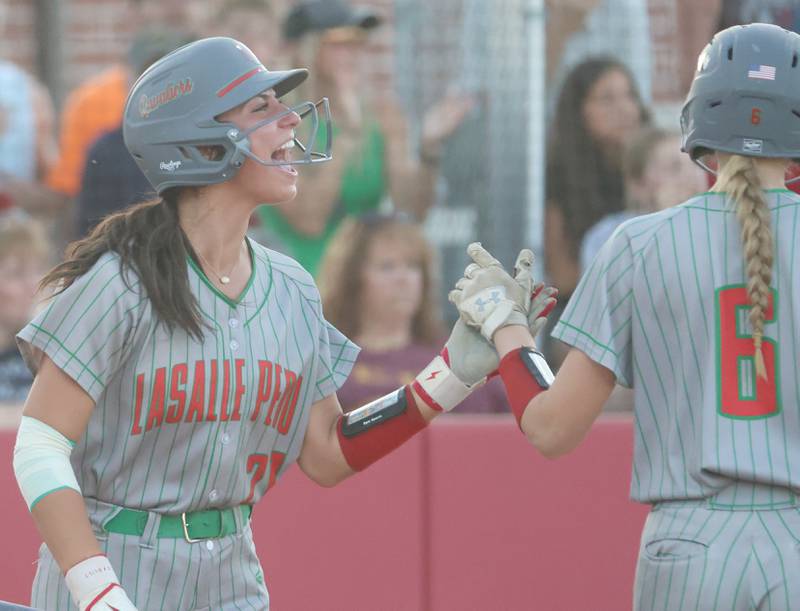 L-P's Anna Riva reacts after scoring a run whie hi-fiving teammate Maggie Boudreau during the Class 3A Sectional semifinal game on Tuesday, May 26, 2026 at the L-P Athletic Complex in La Salle.
