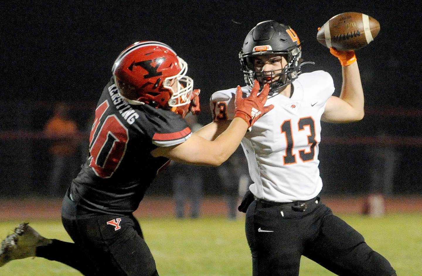 Libertyville quarterback Luka Nikolich (13)m throws a pass under pressure from Yorkville defender Blake Kersting (4) during a class 7A playoff football game at Yorkville High School on Friday, Oct. 28, 2022.