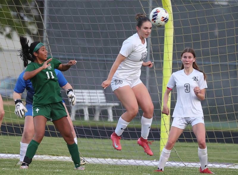 Kaneland's Kyra Lilly heads the ball away from Boylan's MaryTherese Harrison in front of the Kaneland net Wednesday, May 28, 2025, during their Class 2A sectional semifinal game at Belvidere High School.