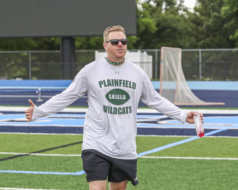 Plainfield Central's head coach Robby Carriger coaches up a player during the Downers Grove South 7 on 7 football tournament, July 12, 2025  in Downers Grove.