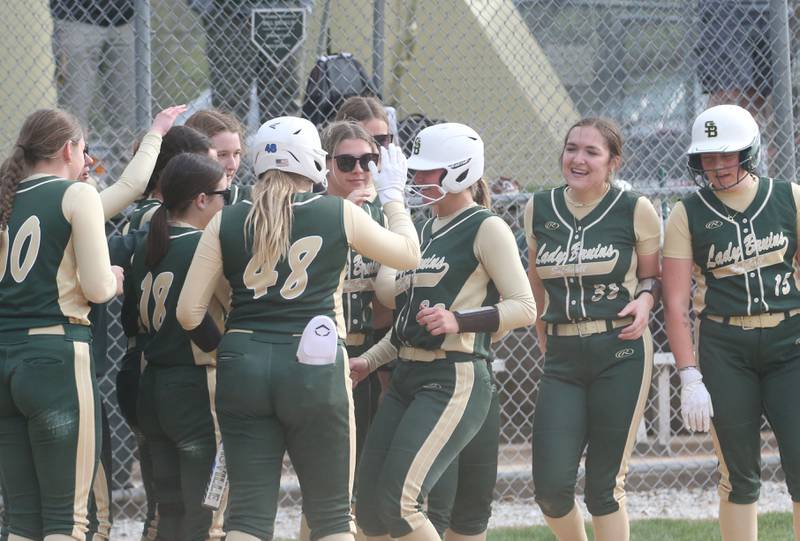St. Bede's Ella Hermes is greeted by her teammates at home plate after hitting a monster home run against Marquette on Monday, April 22, 2024 at St. Bede Academy.