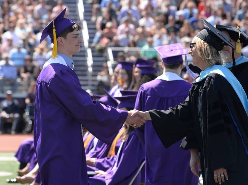Downers Grove North graduates including Matas Beakers receive their diploma during the graduation ceremony held Sunday May 21, 2023.