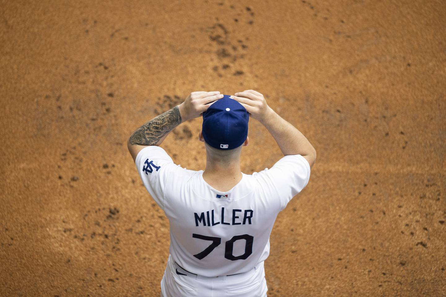 Los Angeles Dodgers starting pitcher Bobby Miller puts his hat on before a facing the Washington Nationals, Monday, May 29, 2023, in Los Angeles.