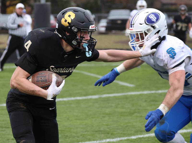 Sycamore's Aidan Wyzard tries to hold off St. Francis' Ryan Palmeri Saturday, Nov. 16, 2024, during their Class 5A quarterfinal game at Sycamore High School.