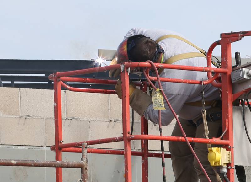 A worker with Vissering Construction welds part of the roof frame on an addition to the west side of Northwest School on Tuesday, Nov. 7, 2023 in La Salle.