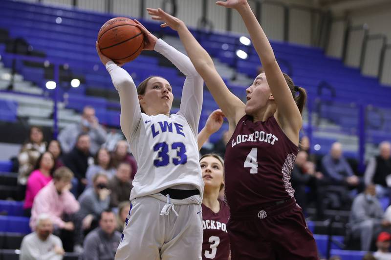 Lincoln-Way East’s Lana Kerley puts a shot over Alaina Peetz of Lockport in the Class 4A Lincoln-Way East Regional semifinal. Monday, Feb. 14, 2022, in Frankfort.