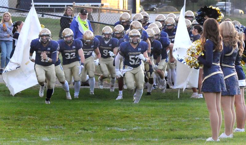 The Marquette Crusaders take to the field Friday night during their home opener against Madison.