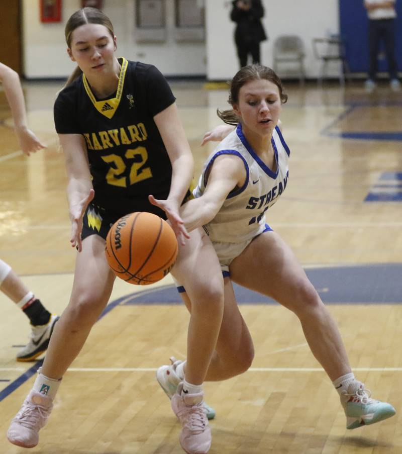 Woodstock's Emma Douglas (right) tries to steal the ball from Harvard's Summer Jones during a Kishwaukee River Conference girls basketball game on Monday Jan. 12, 2026, at Woodstock High School.