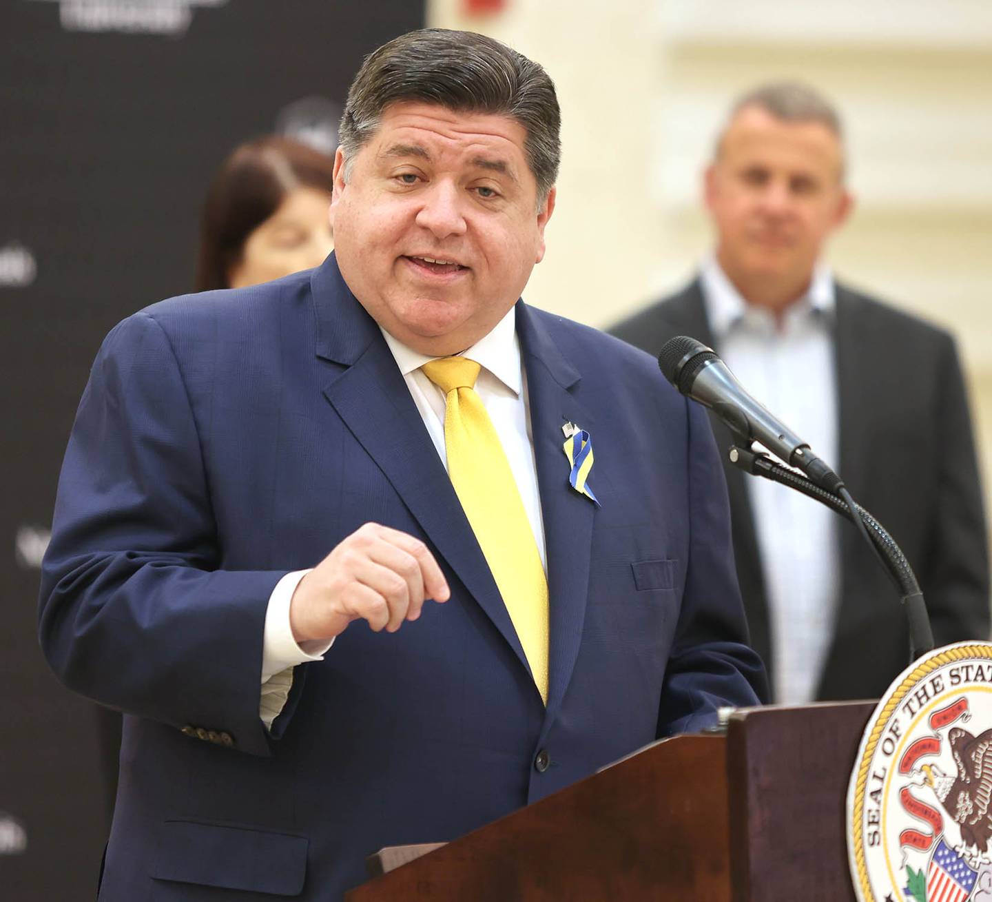Illinois Gov. JB Pritzker speaks as DeKalb Mayor Cohen Barnes looks on Thursday, March 3, 2022, in the Barsema Alumni and Visitors Center at Northern Illinois University in DeKalb. Pritzker was on hand to talk about the importance of higher education and to tout some of the programs in Illinois that help make that education more accessible to all.