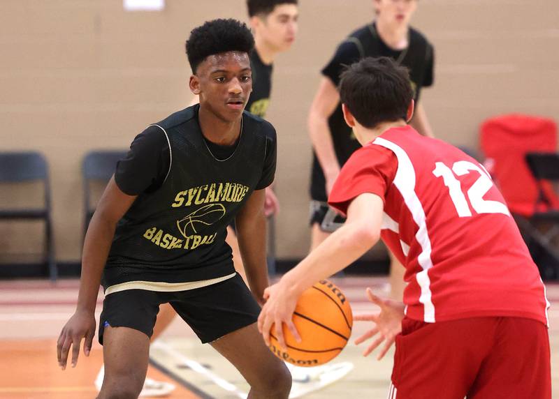 Sycamore’s Lamarrio Moore plays defense Friday, June 20, 2025, during their game against Marmion in the DeKalb Live summer tournament at DeKalb High School.
