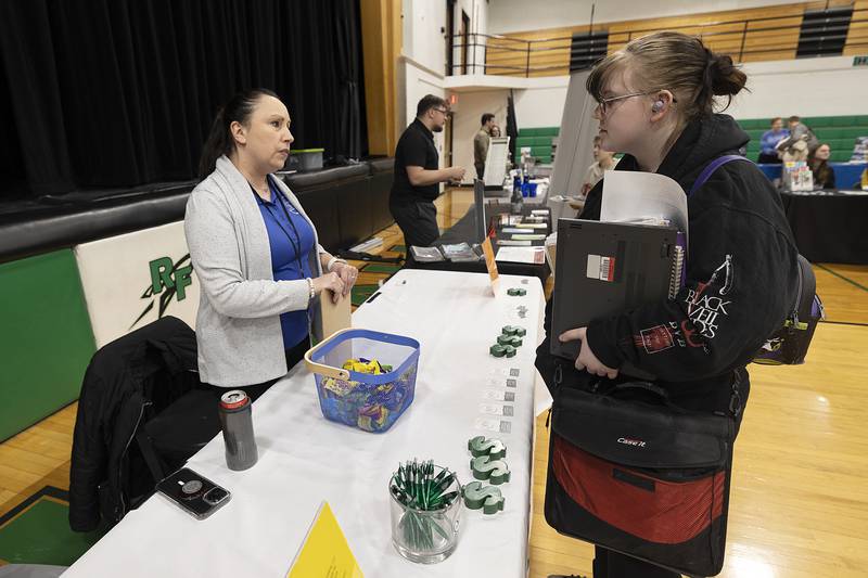 Anna Garcia, administrative manager at Steel River Systems in Rock Falls, speaks with RFHS senior Jamie Swords Thursday, March 6, 2025, during the school’s college and career fair. Not only was Garcia telling the students about the business she was helping them with job interview skills.