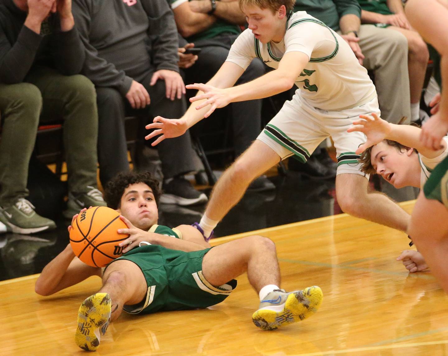 St. Bede's Jose De La Torre falls on a loose ball as Eureka's Cooper Peterson defends during the 50th annual Colmone Classic on Monday, Dec. 9, 2024 at Hall High School.