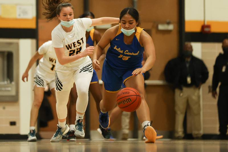 Joliet Central’s Lovely Tua-Link beats Joliet West’s Grace Walsh to the loose ball. Tuesday, Feb. 8, 2022, in Joliet.