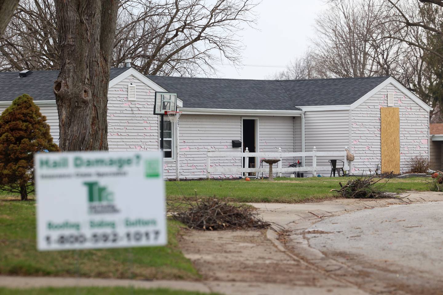 Debris is piled on the curb near a home with hail damage on NW Circle Drive in Bradley on March 26, 2026, following the March 10 storms that passed through Kankakee County.