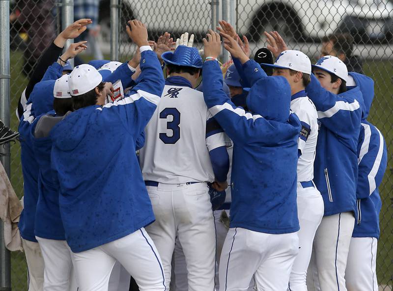 Burlington Central's Andrew Payton is mobbed by his teammates after he hit a rand slam during a Fox Valley Conference baseball game on Friday, April 12, 2024, at Burlington Central High School.