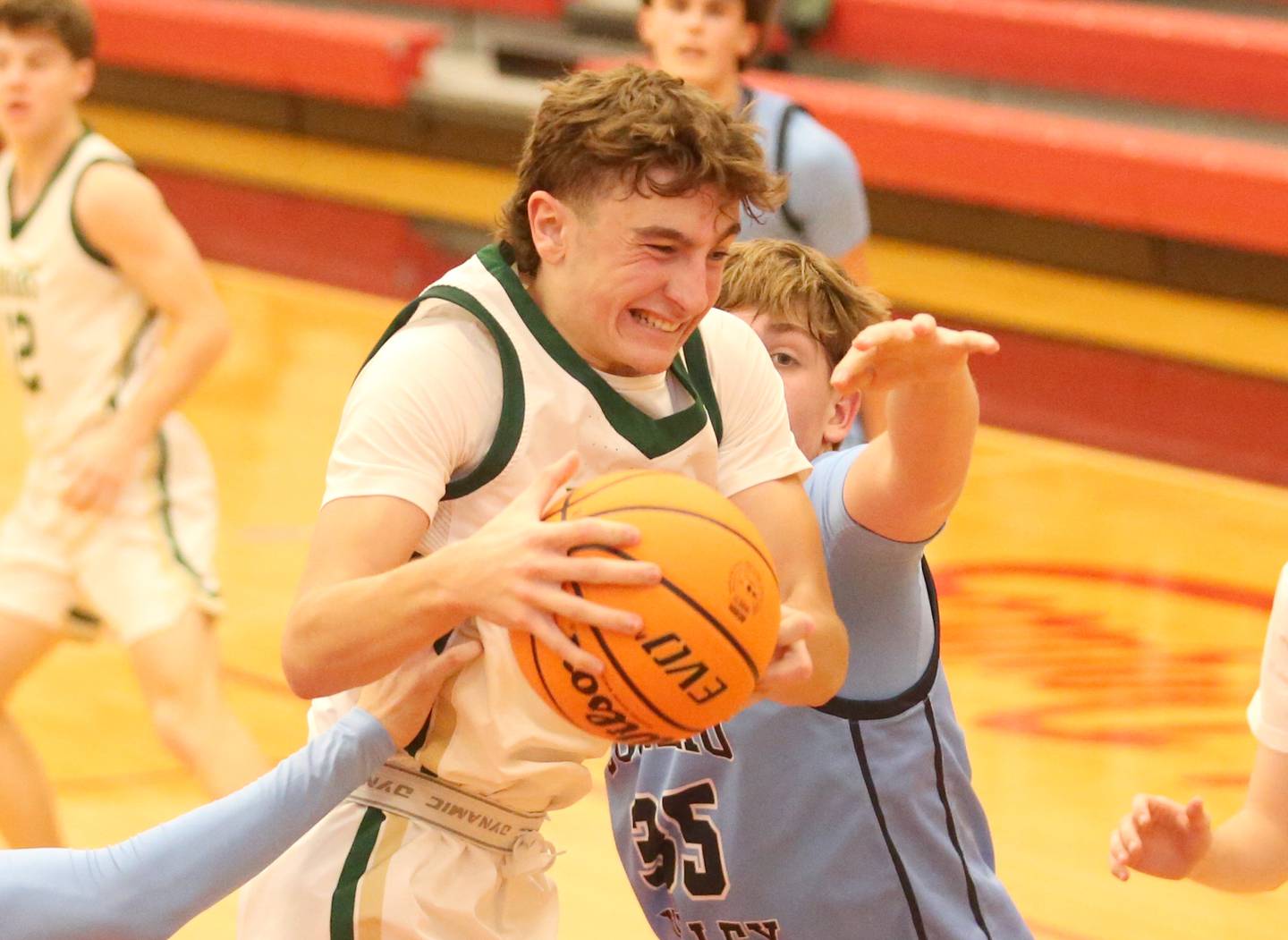 St. Bede's Gino Ferrari grabs a rebound over Bureau Valley's Brad Schoff during the 50th annual Colmone Classic on Thursday, Dec. 12, 2024 at Hall High School.