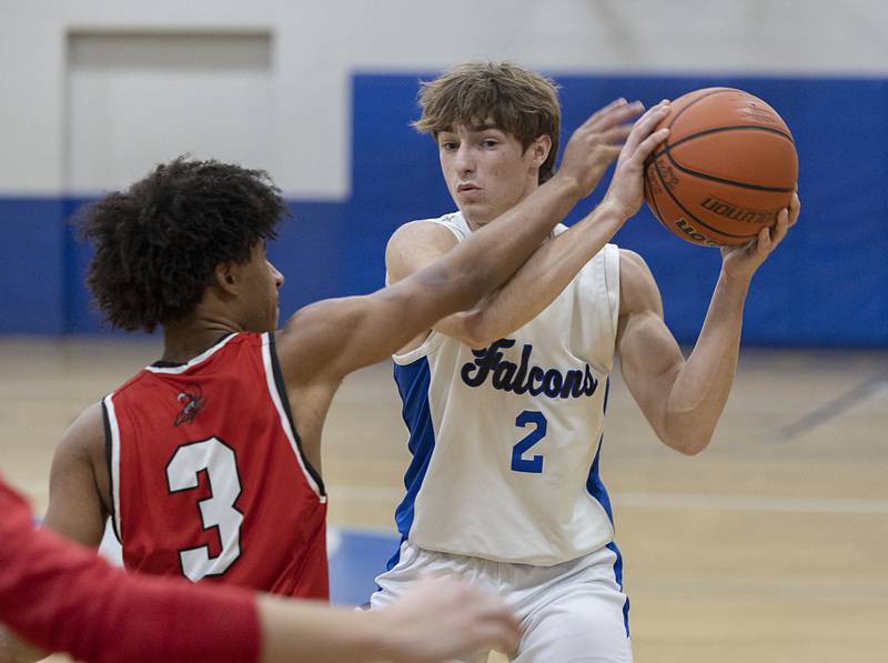 Faith Christian’s Carson Bivins looks to make a play against QC Christian’s Alijah Zentic Tuesday, Dec. 9, 2025.