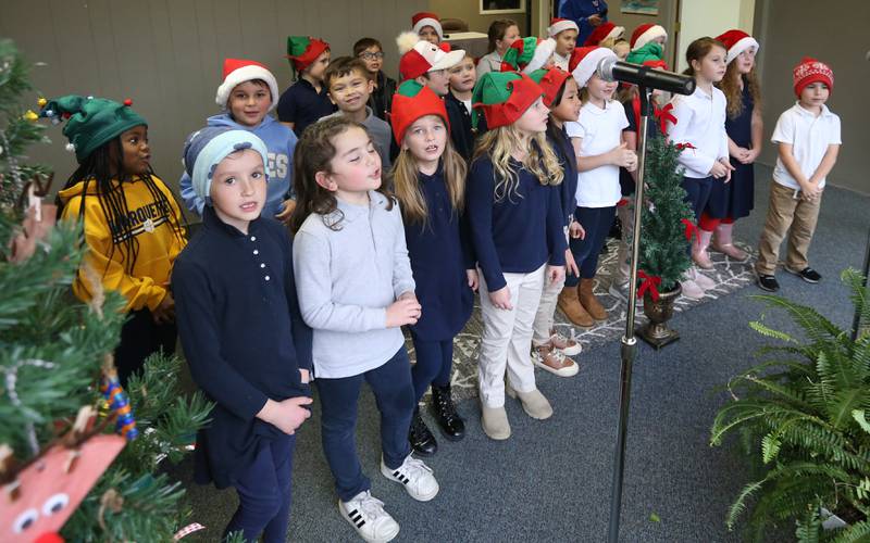 Marquette Academy Grade School first grade students sing Christmas carols during the Freezin' for a Reezin' on Friday, Dec. 1, 2023 in Ottawa. Donations from the event benefited the Ottawa Community Basket.