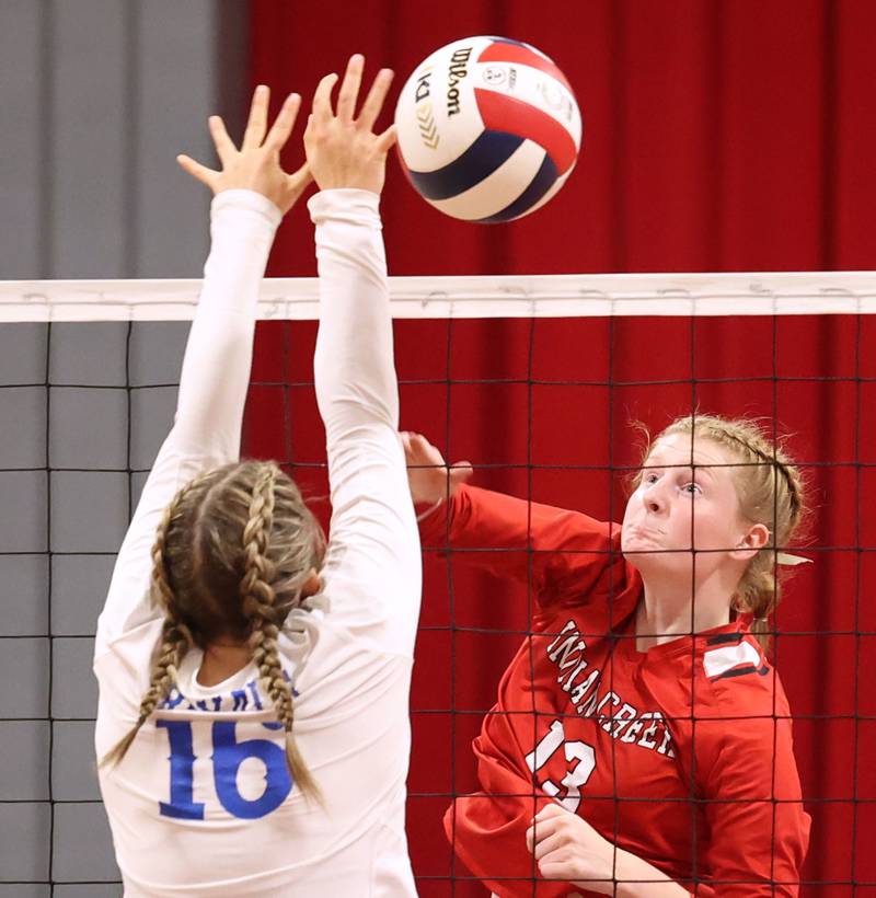 Indian Creek's Allie Peterson tries to spike the ball by Hinckley-Big Rock's Grace Barrett during their match Tuesday, Sept. 19, 2023, at Indian Creek High School in Shabbona.