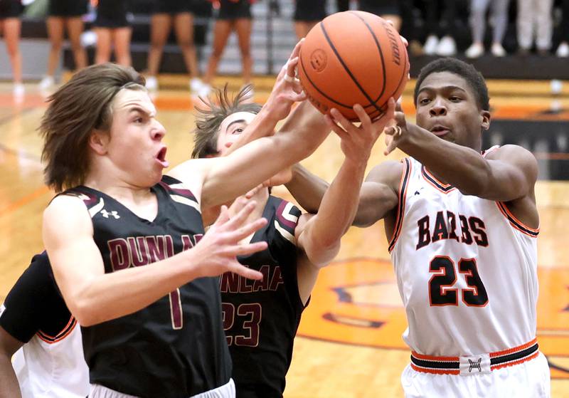 DeKalb's Davon Grant and Dunlap's Gabe Munoz fight for a rebound in a group of Dunlap players during their game Monday, Nov. 21, 2022, at DeKalb High School.