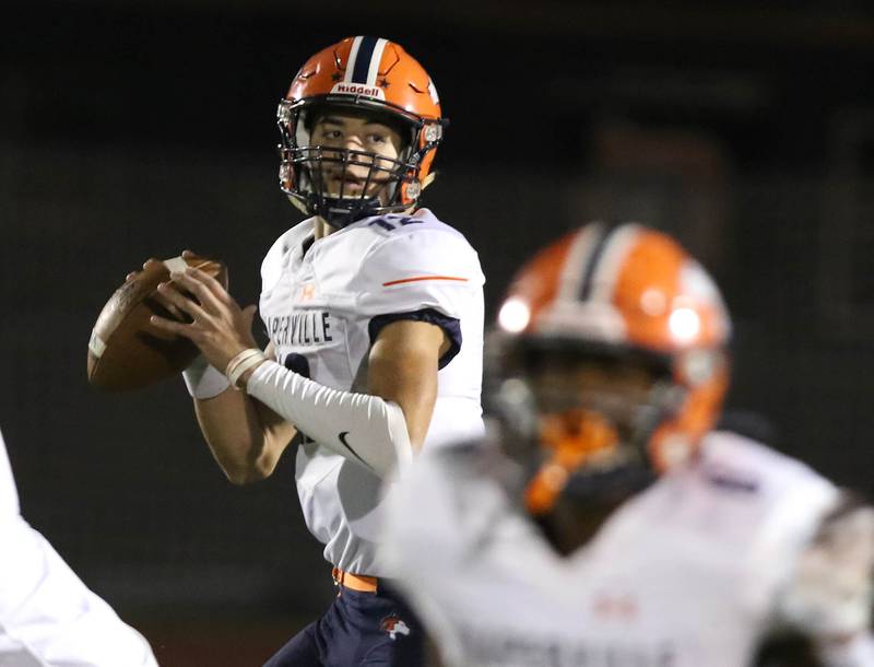 Naperville North quarterback Aidan Gray looks for a receiver during their game Friday Sep. 25, 2021 at DeKalb High School.