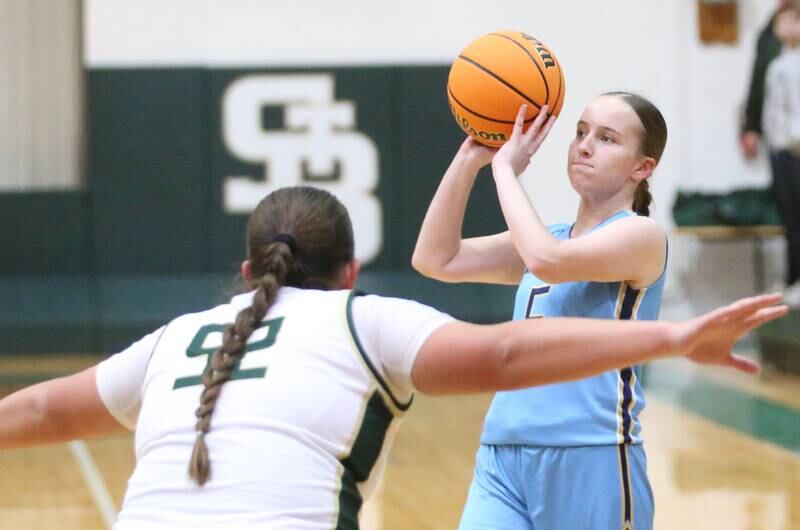 Marquette's Chloe Larson looks to pass the ball around St. Bede's Ava Balestri on Monday, Dec. 2, 2024 at St. Bede Academy.