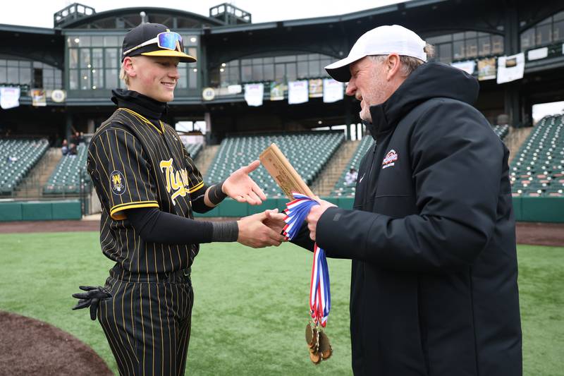 Joliet West’s Keegan Schwarting accepts the tournament MVP plaque from WJOL’s Scott Slocum after the Tigers win over Lockport in the WJOL Don Ladas Memorial baseball tournament championship game on Saturday, April 4, 2026 in Joliet.