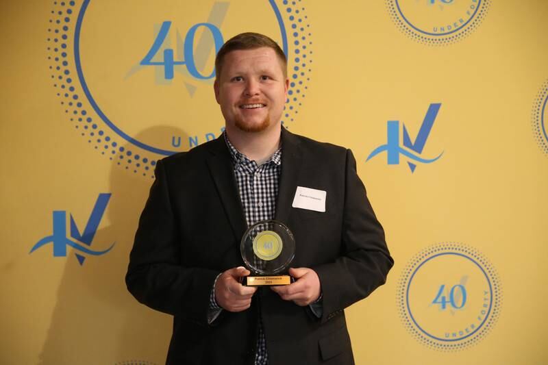 Patrick Chismarick poses for a photo with his award during the 40 Under Forty awards banquet on Thursday, March 21, 2024 at Westclox in Peru.