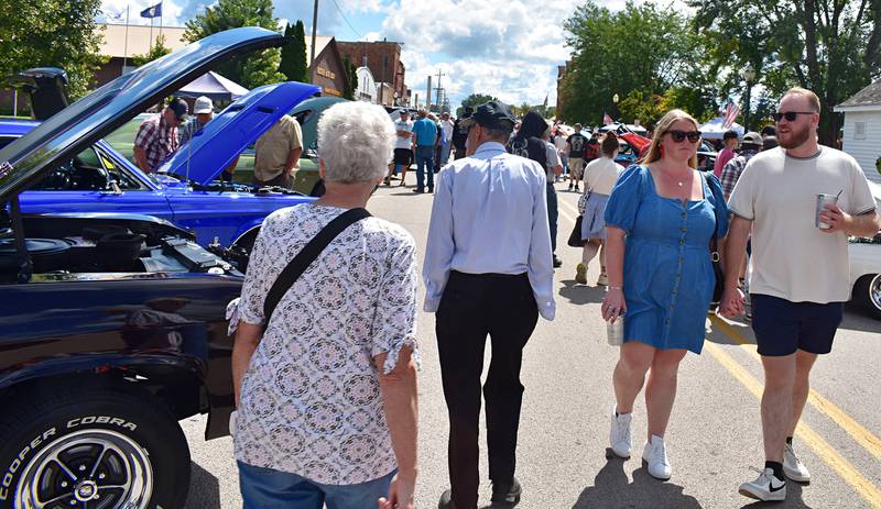 Crowds of people admire the cars at the Depot Days car show in Amboy on Sunday, Aug. 24, 2025.