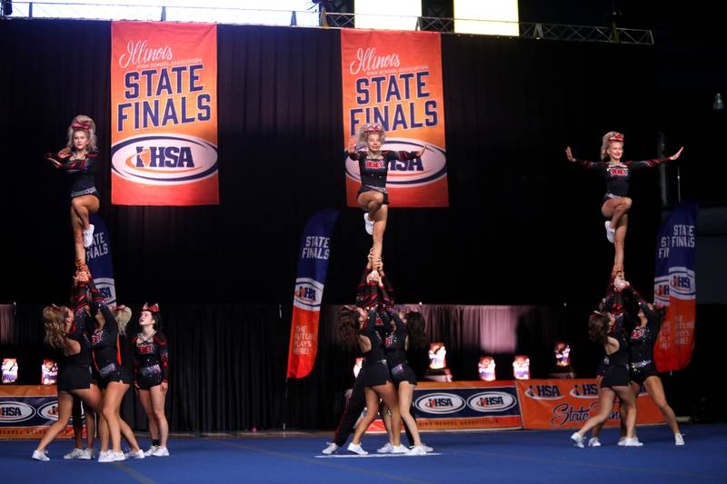Members of the Benet Academy cheerleading team compete in the medium team division of the IHSA State Finals on Saturday, Feb. 8, 2025 at Grossinger Motors Arena in Bloomington.