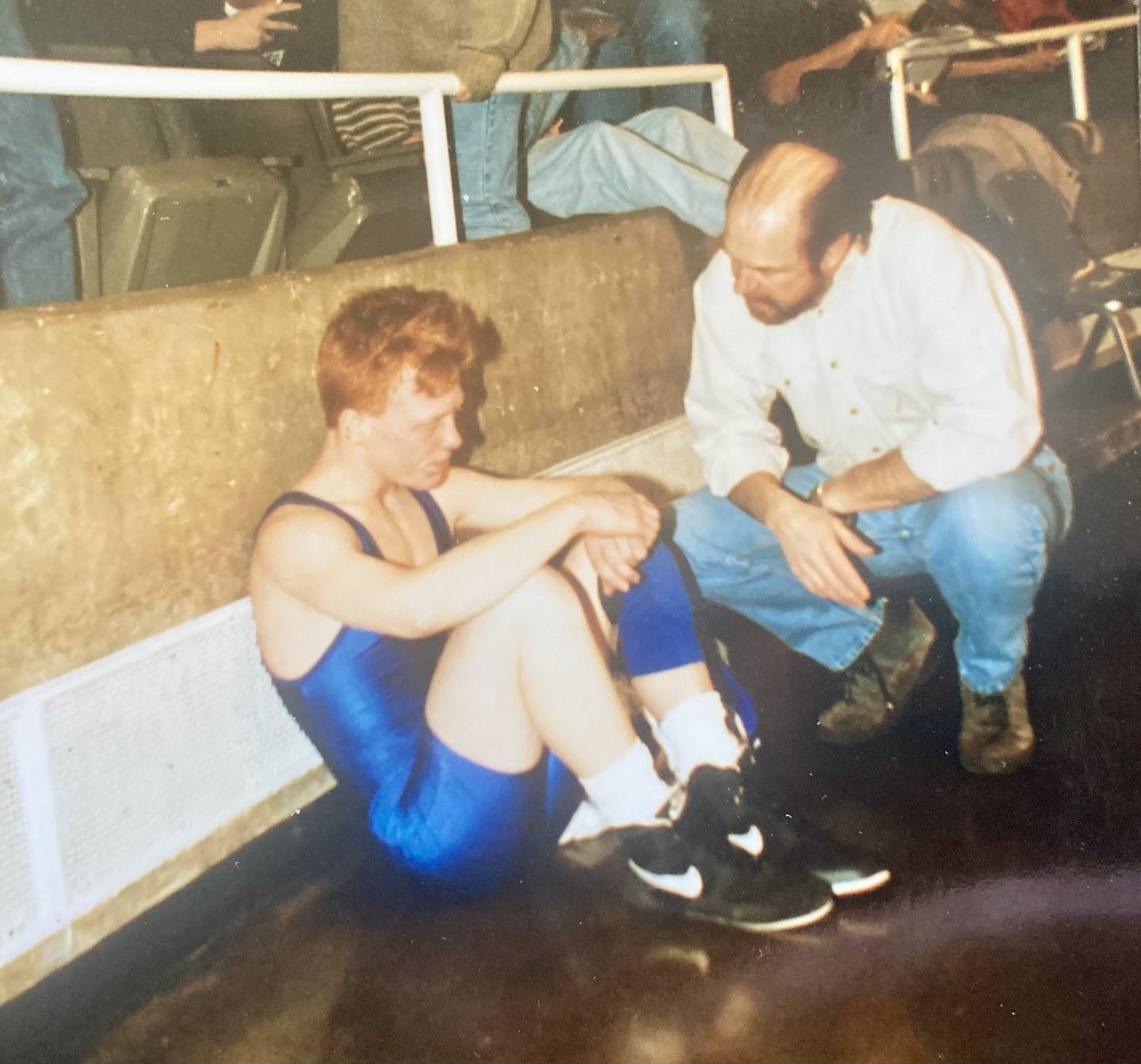 The late Princeton coach Randy Swinford consoles Josh Anderson, then a PHS senior during the 1996 IHSA State Wrestling Tournament at the Assembly Hall. Anderson, who placed third in the PIT that year, will be officiating this year's tournament at his alma mater.