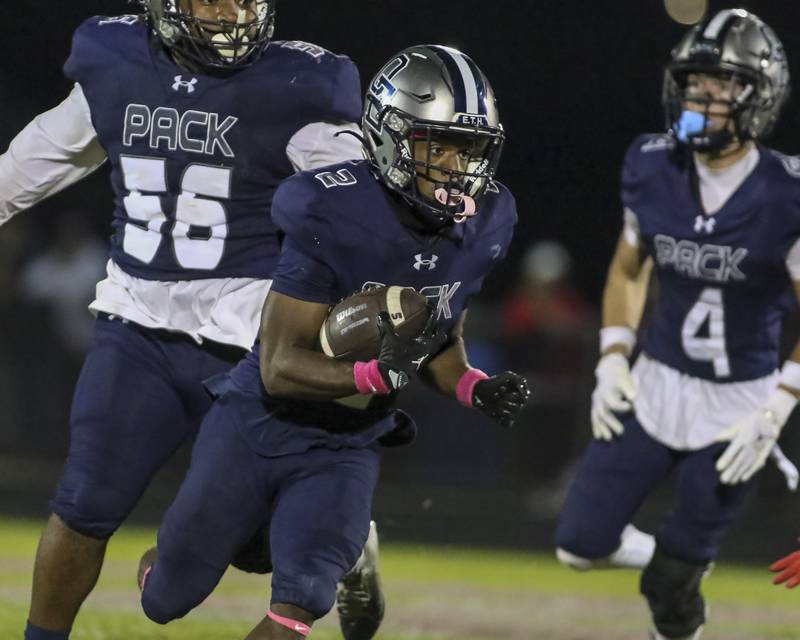 Oswego East's Jasiah Watson (2) looks for running room during football game between Yorkville at Oswego East Friday, Oct 10, 2025 in Oswego.