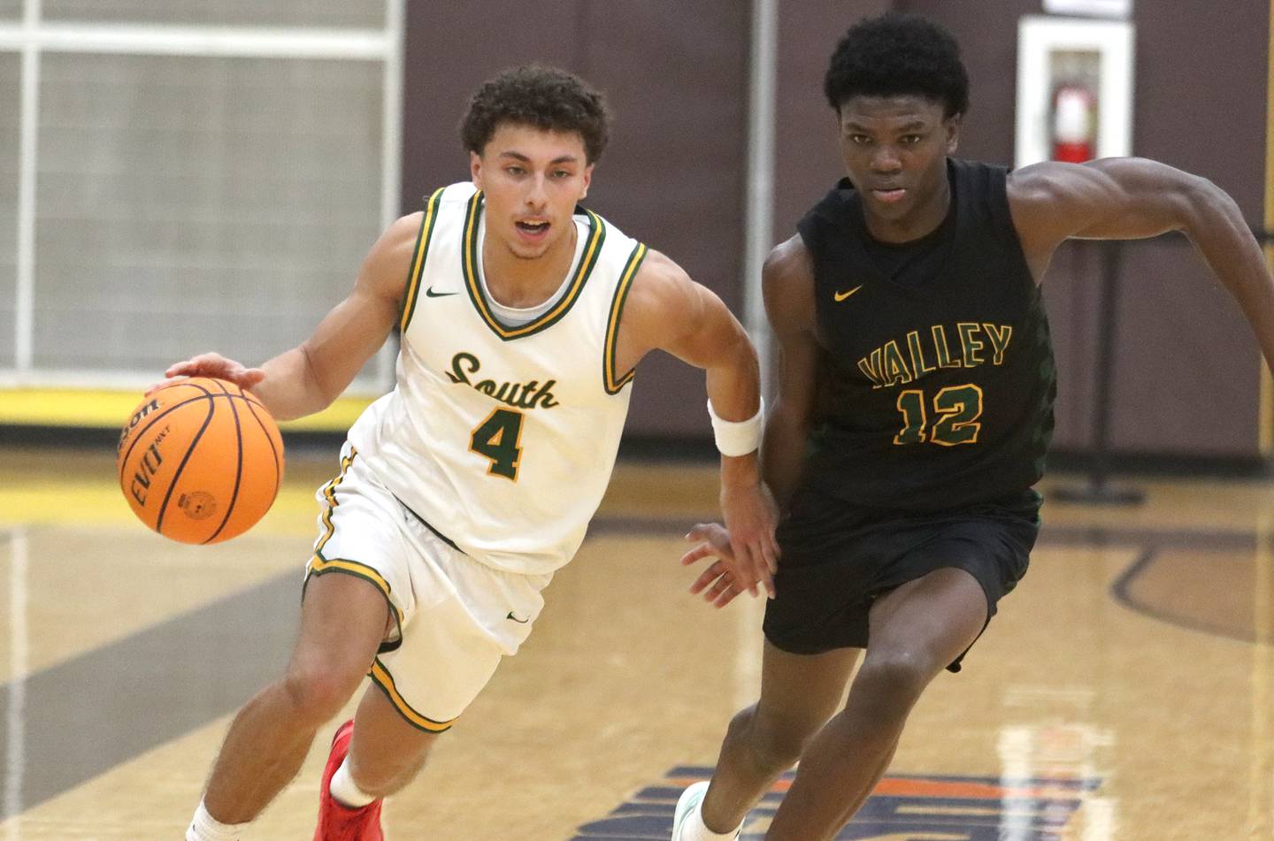 Crystal Lake South’s AJ Demirov, left, races past Waubonsie Valley’s Tyreek Coleman  during Hinkle Holiday Classic varsity boys basketball tournament title game action on Friday, Dec. 27, 2024 at Jacobs High School in Algonquin.