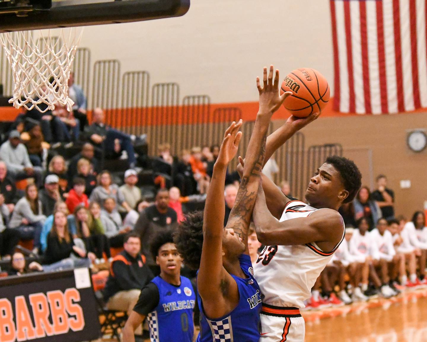 DeKalb's Davon Grant, right, makes a basket while being defended by Phillips's Cordell Broughton , in the second quarter of the championship game of the Dayton Classic tournament held at DeKalb High School.