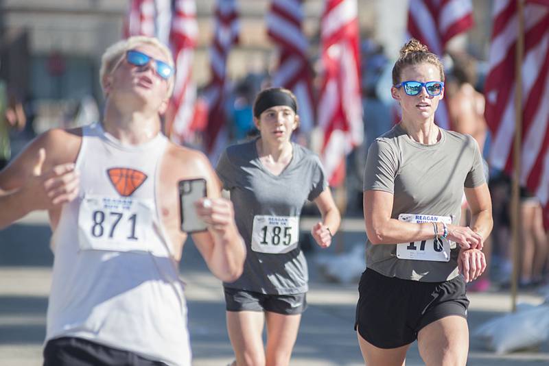 Breanne Hunter (right) crosses the finish line Saturday, July 2, 2022 in the Reagan Run. Hunter came in 48 overall and second in the women’s.