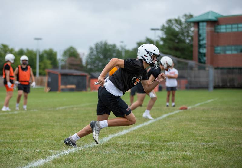 Wide receiver Mason Tousignant runs a drill during practice at St. Charles East on Monday, Aug. 8, 2022.